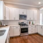 Sparkling clean white kitchen and stainless steel appliances after a professional house cleaning service in Georgetown TX.
