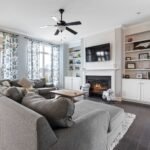 Family room with a large sectional sofa, neat wood floors, and clean surfaces, illustrating the results of professional house cleaning service in Westlake Hills TX.