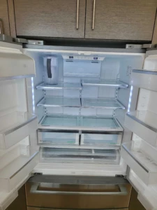 Empty refrigerator with shelves removed and deep cleaned to remove allergens, a key part of our Move In Cleaning Austin package.
