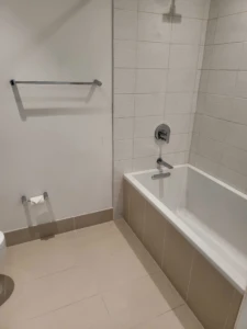 Disinfected bathtub and tile grout scrubbed to remove previous-owner residue, ensuring a hygienic Move in deep cleaning result.